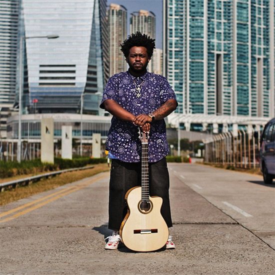 James Fauntleroy In The Street With Guitar