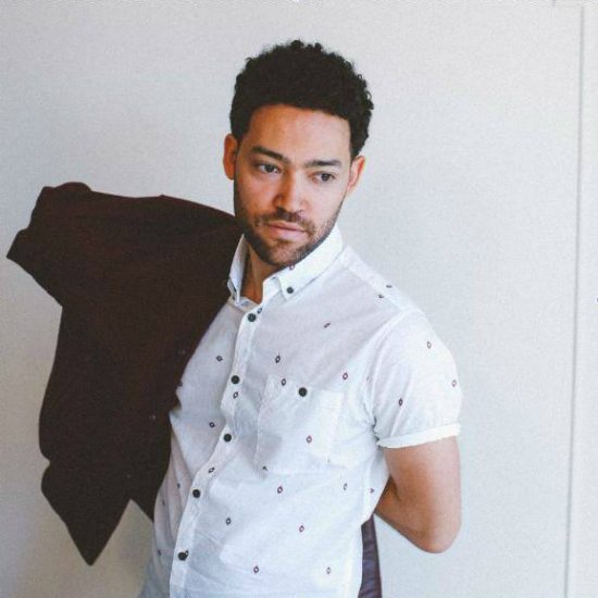 taylor-mcferrin-putting-on-brown-jacket