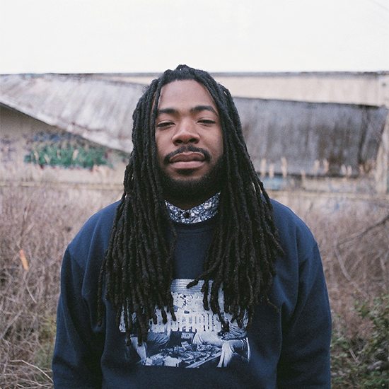 DRAM In Sweatshirt In Front Of Trees