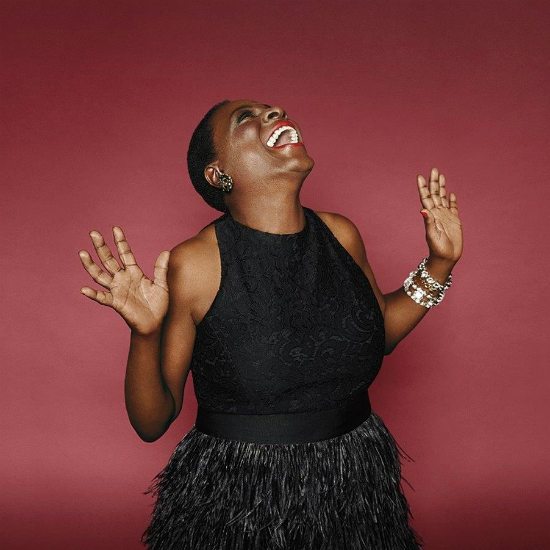 sharon-jones-black-dress-red-background